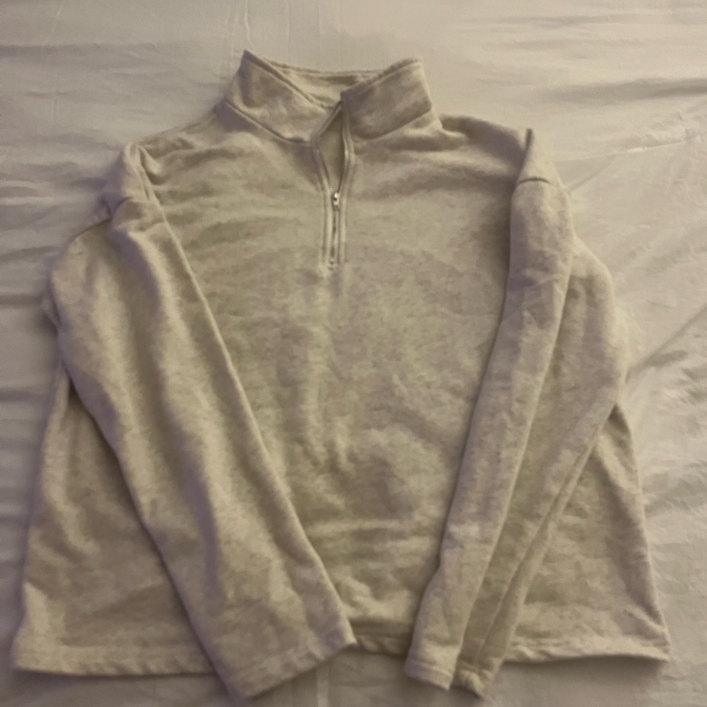 Crew neck. Zip up on neck.